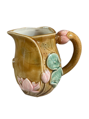 Majolica hand painted stoneware pitcher with floral design